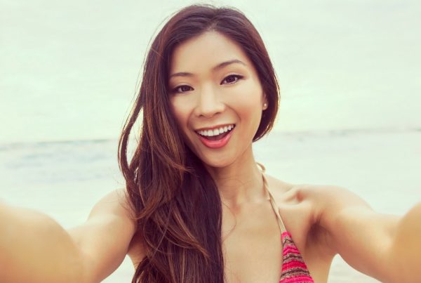 Woman taking a selfie for Instagram. How often should I post on Instagram for my Business?