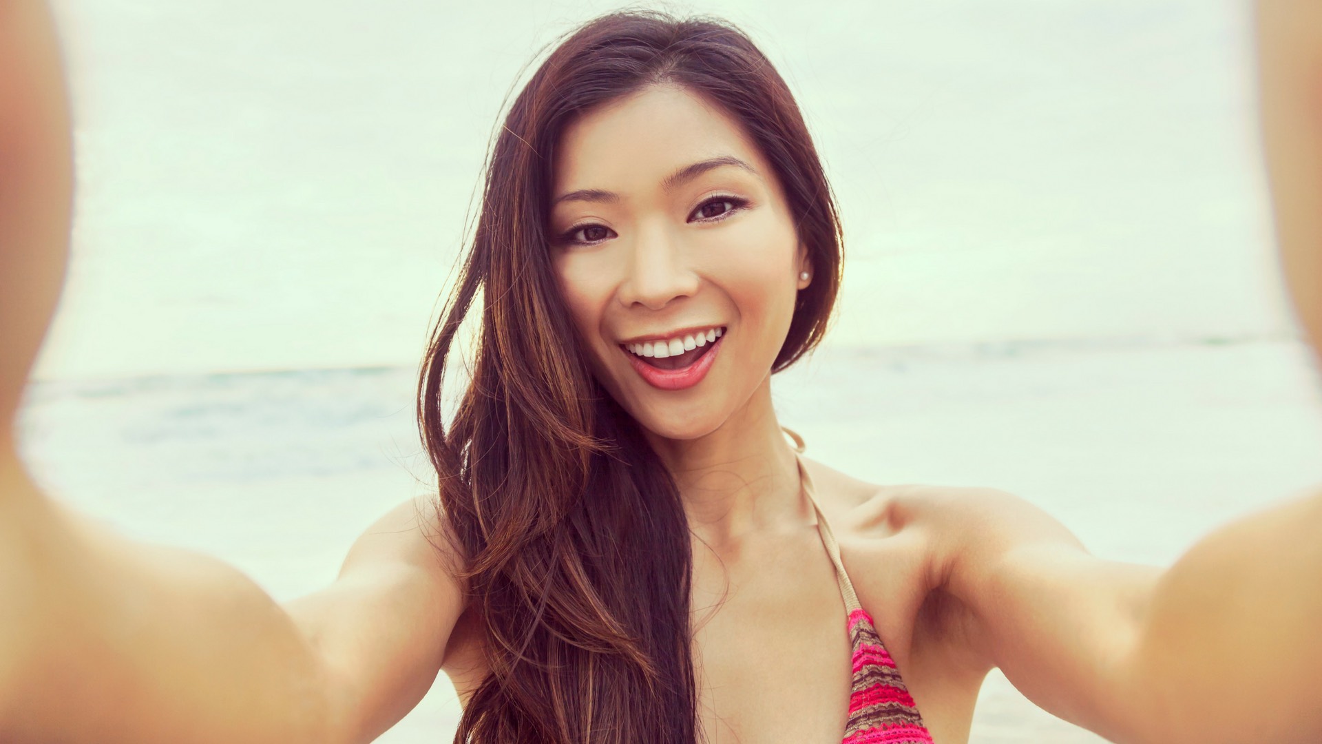 Woman taking a selfie for Instagram. How often should I post on Instagram for my Business?